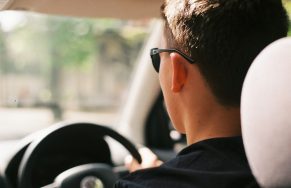 Man Driving Car Wearing Black Sunglasses and Shirt